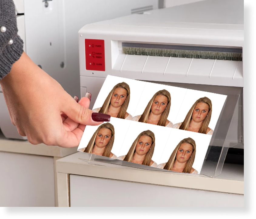 Printed portrait photos coming out of a photo printer