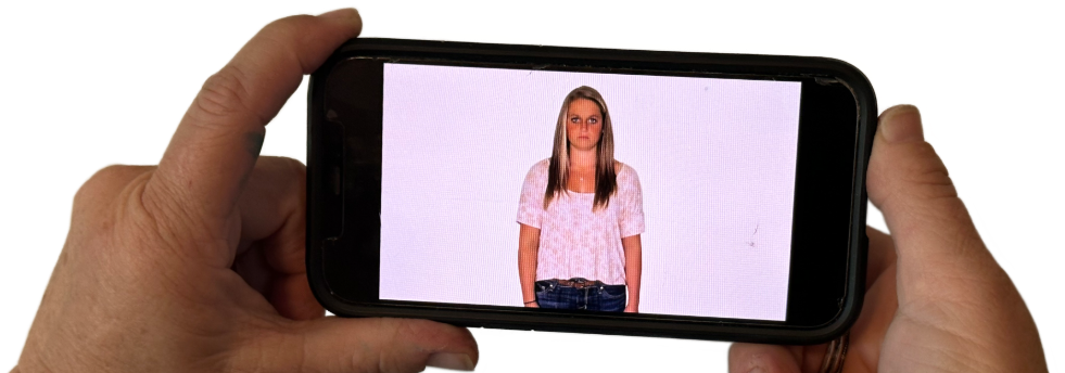Hands holding a phone horizontally to take a portrait